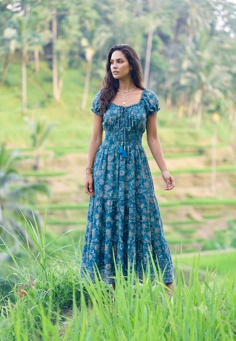 Woman wearing Off Shoulder Silk Maxi Dress from Coral Secret standing in a Bali Rice Terrace
