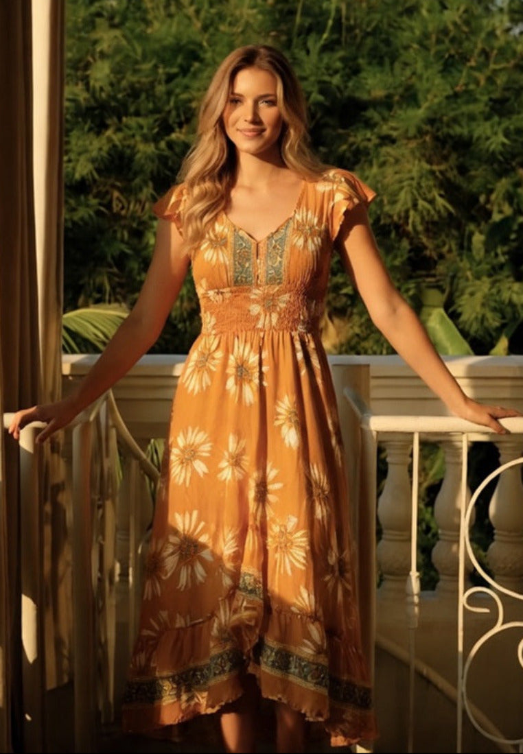 woman in Sunflower Silk Midi Dress with Open Back from coral secret