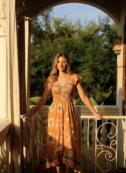 woman in floral yellow Silk Midi Dress with Open Back from coral secret